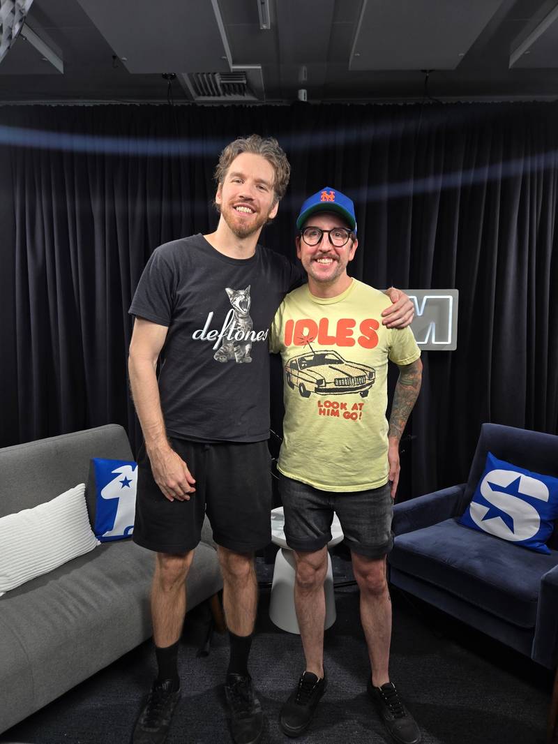 Kyle posing with a friend in a studio